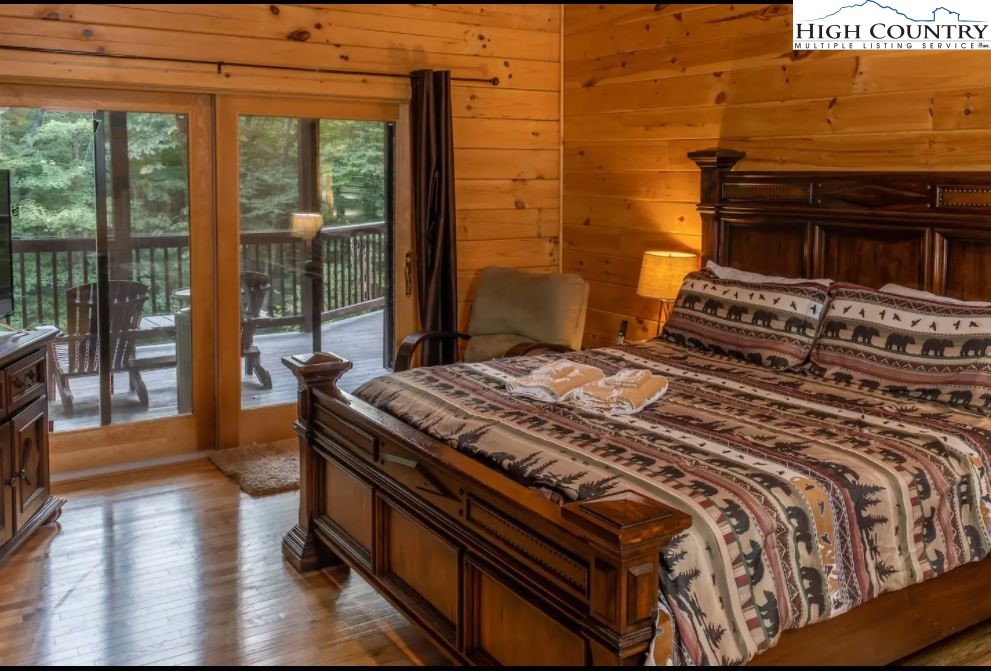 124 Aster Trail Beech Mountain, NC 28604 - Photo 7 of 26 a bed sitting in a bedroom next to a window