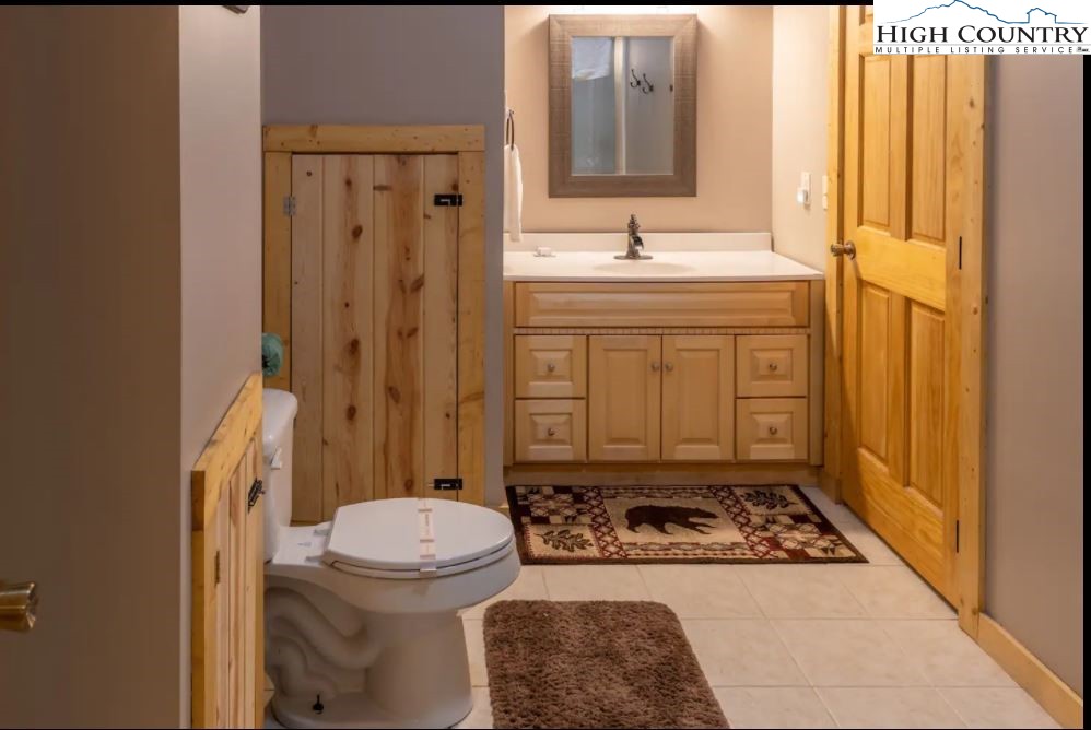 124 Aster Trail Beech Mountain, NC 28604 - Photo 8 of 26 a bathroom with a sink toilet and shower