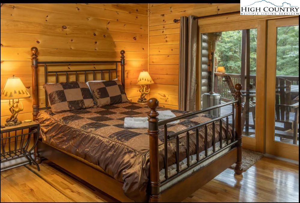 124 Aster Trail Beech Mountain, NC 28604 - Photo 9 of 26 a bedroom with a bed and wooden floor