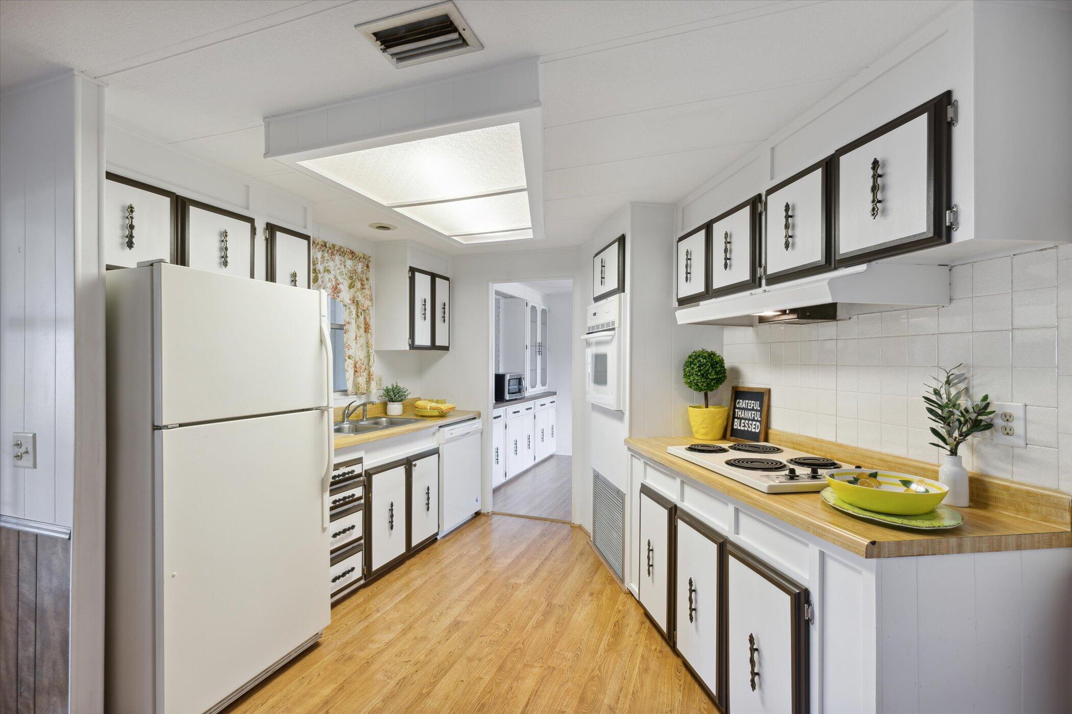 554 Ruth Circle Melbourne, FL 32904 - Photo 16 of 36 a kitchen with stainless steel appliances granite countertop a refrigerator a stove and a dining table