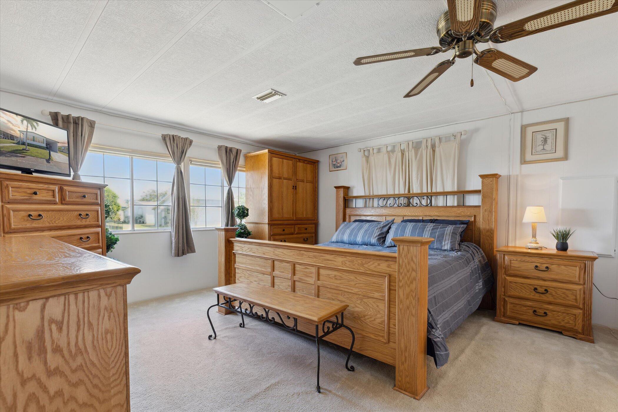 554 Ruth Circle Melbourne, FL 32904 - Photo 19 of 36 a bedroom with a bed and a chandelier