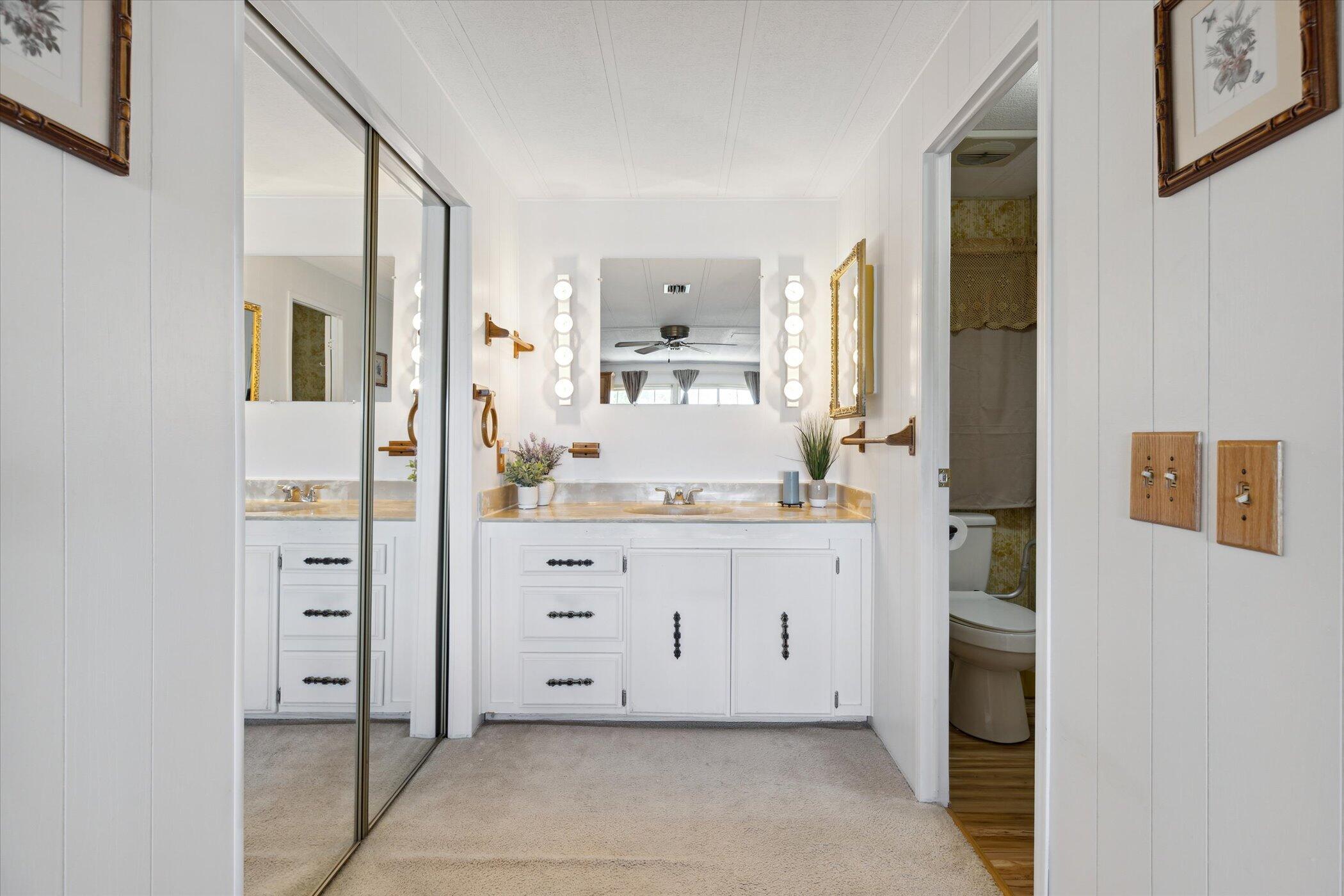 554 Ruth Circle Melbourne, FL 32904 - Photo 22 of 36 a bathroom with a double vanity sink and mirror