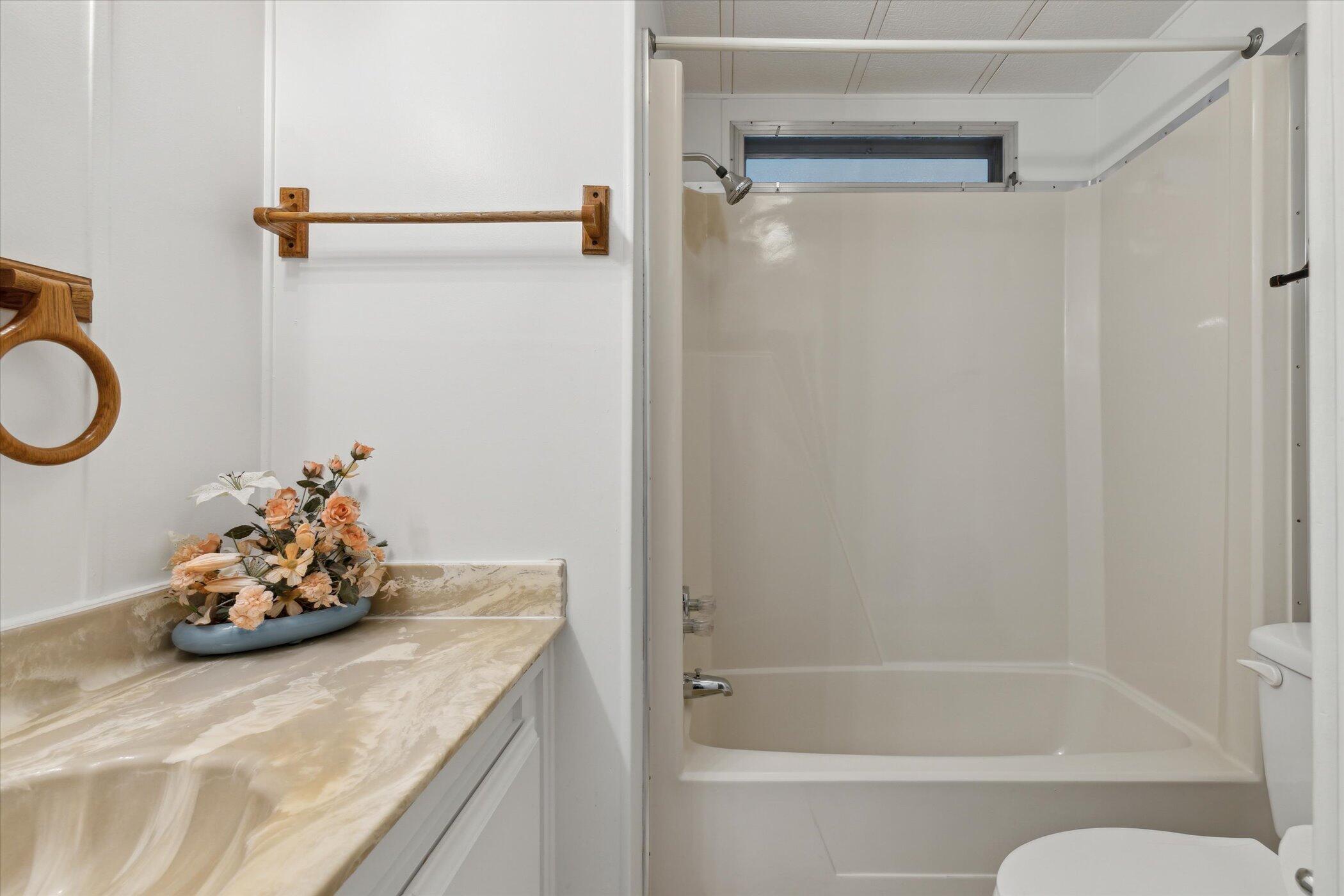 554 Ruth Circle Melbourne, FL 32904 - Photo 28 of 36 a bathroom with a tub sink and a mirror