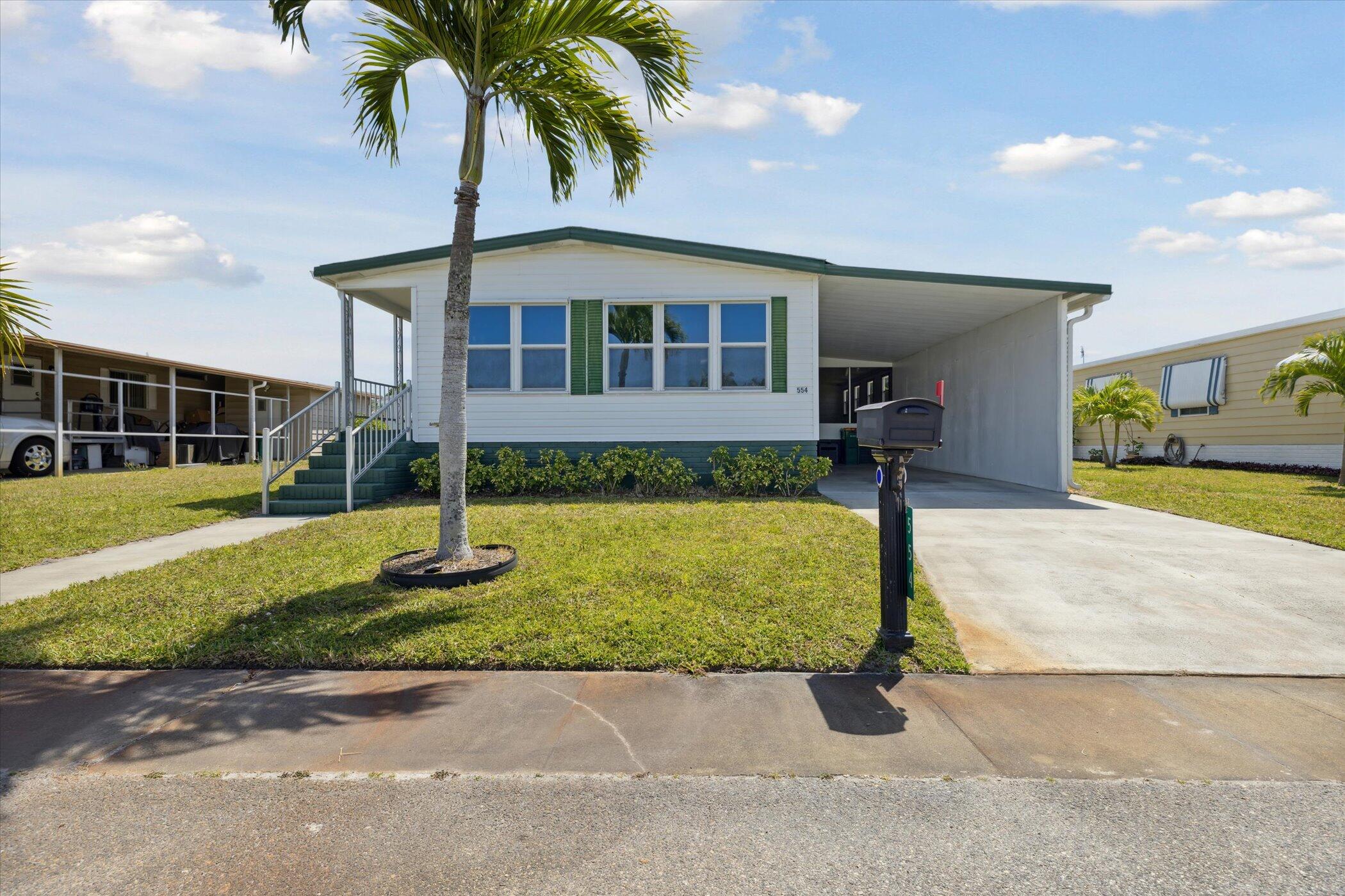 554 Ruth Circle Melbourne, FL 32904 - Photo 3 of 36 a front view of a house with a garden and plants