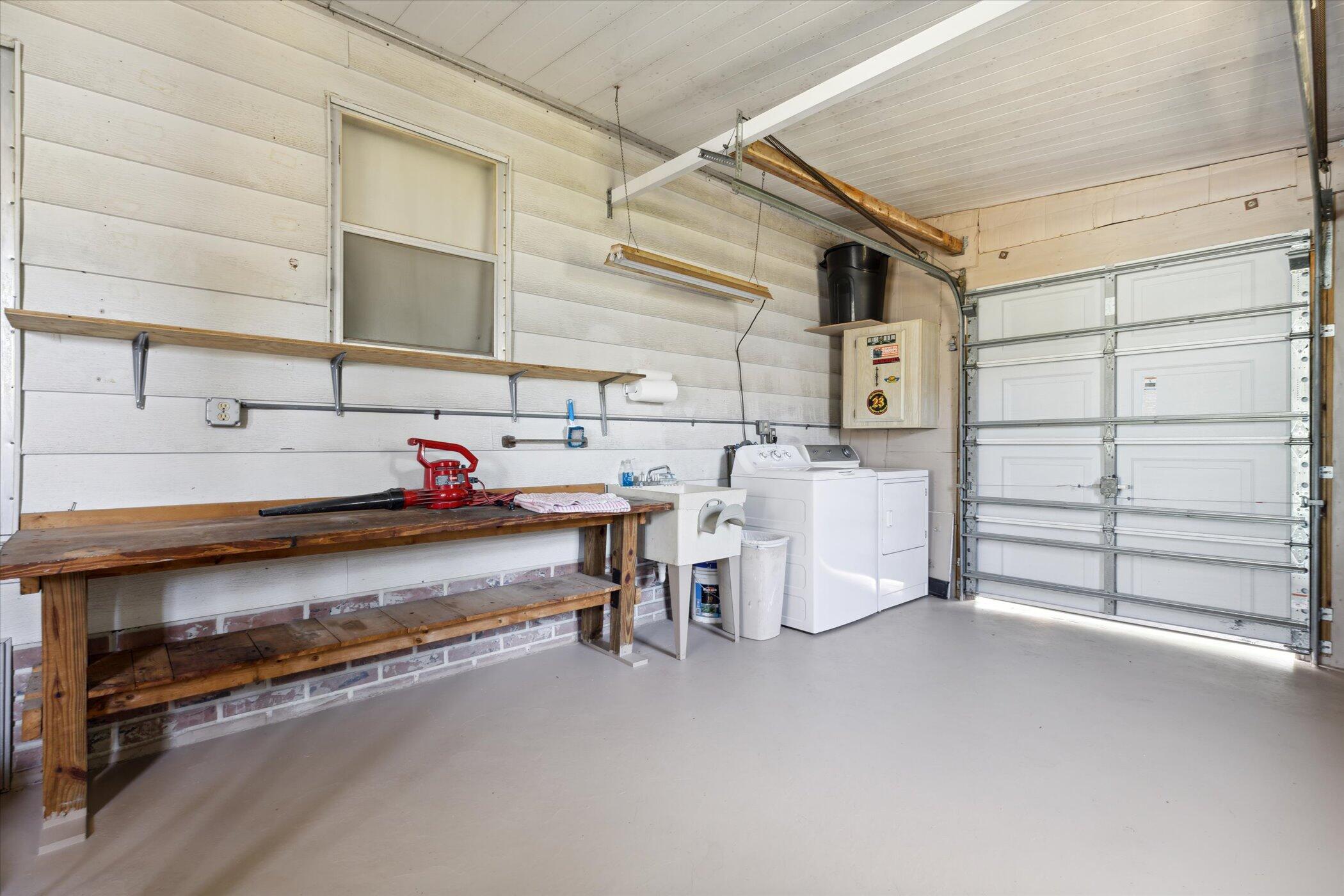 554 Ruth Circle Melbourne, FL 32904 - Photo 31 of 36 a storage room with water heater and racks