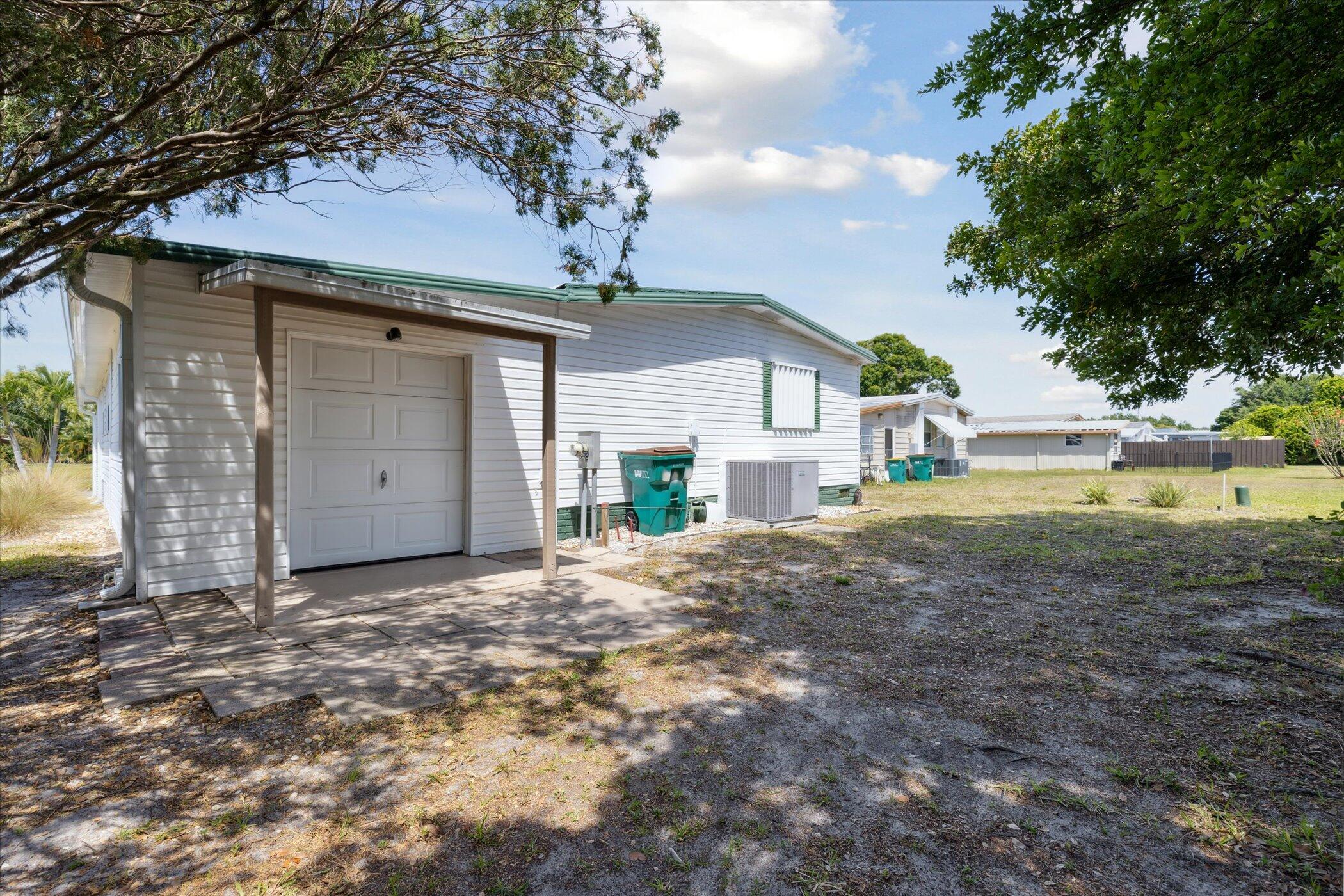 554 Ruth Circle Melbourne, FL 32904 - Photo 33 of 36 a front view of a house with a yard and garage