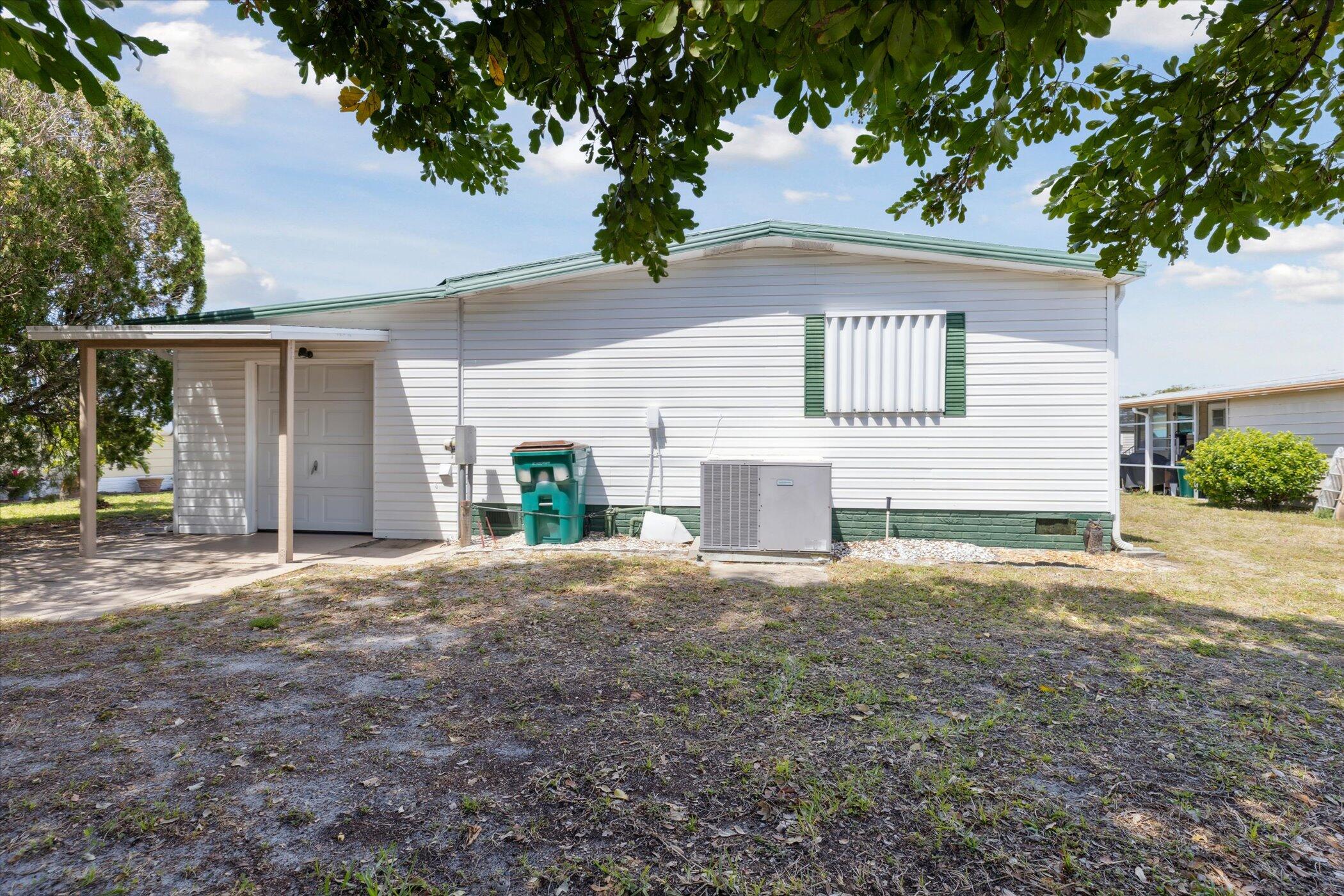 554 Ruth Circle Melbourne, FL 32904 - Photo 34 of 36 a front view of a house with a yard and garage