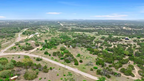 a view of a city with lush green forest