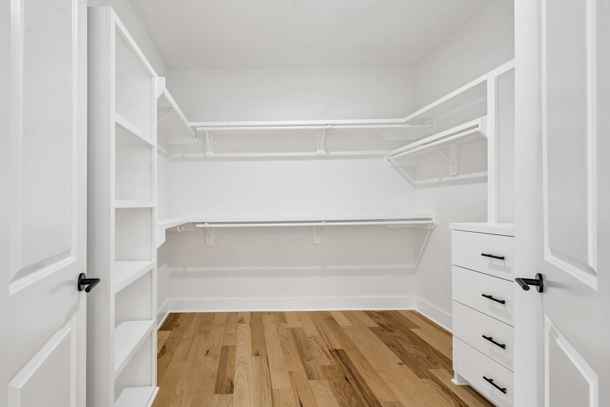 424 Sikes Street Houston, TX 77018 - Photo 8 of 12 a view of walk in closet with empty racks