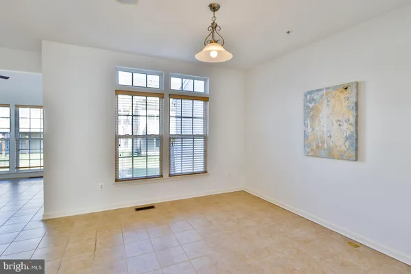 a kitchen with stainless steel appliances granite countertop a stove top oven a sink a counter space and cabinets