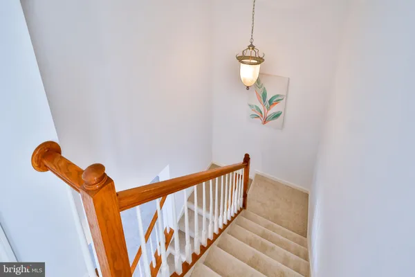 a view of a hallway with wooden floor and entryway
