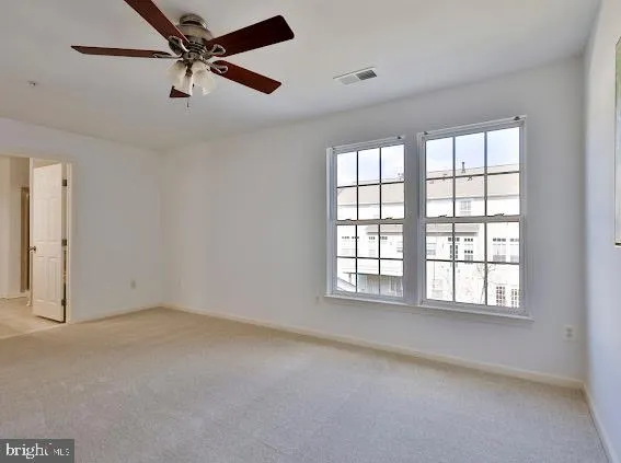 a kitchen with stainless steel appliances granite countertop a refrigerator a stove top oven a sink and dishwasher