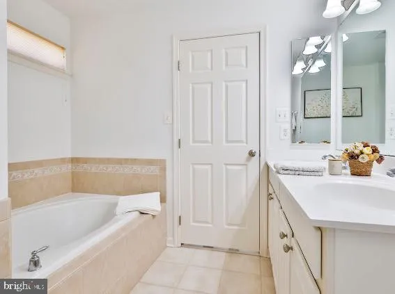 a bathroom with a sink mirror and vanity