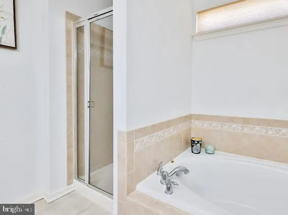 a view of an empty room with wooden floor and windows