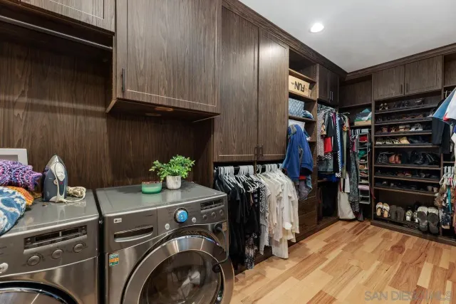 a view of walk in closet with clothes and shoes