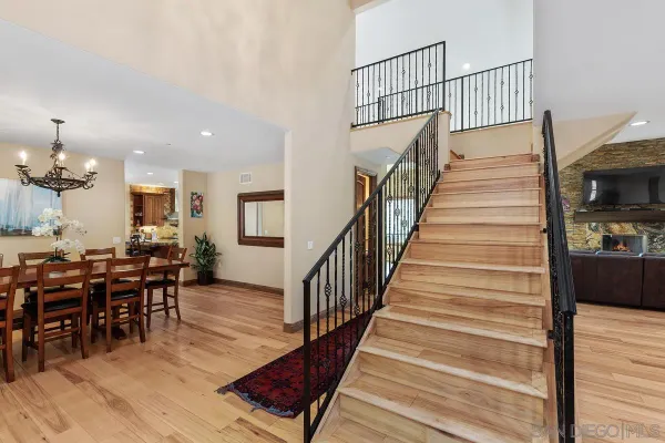 a view of a dining room and hall with wooden floor