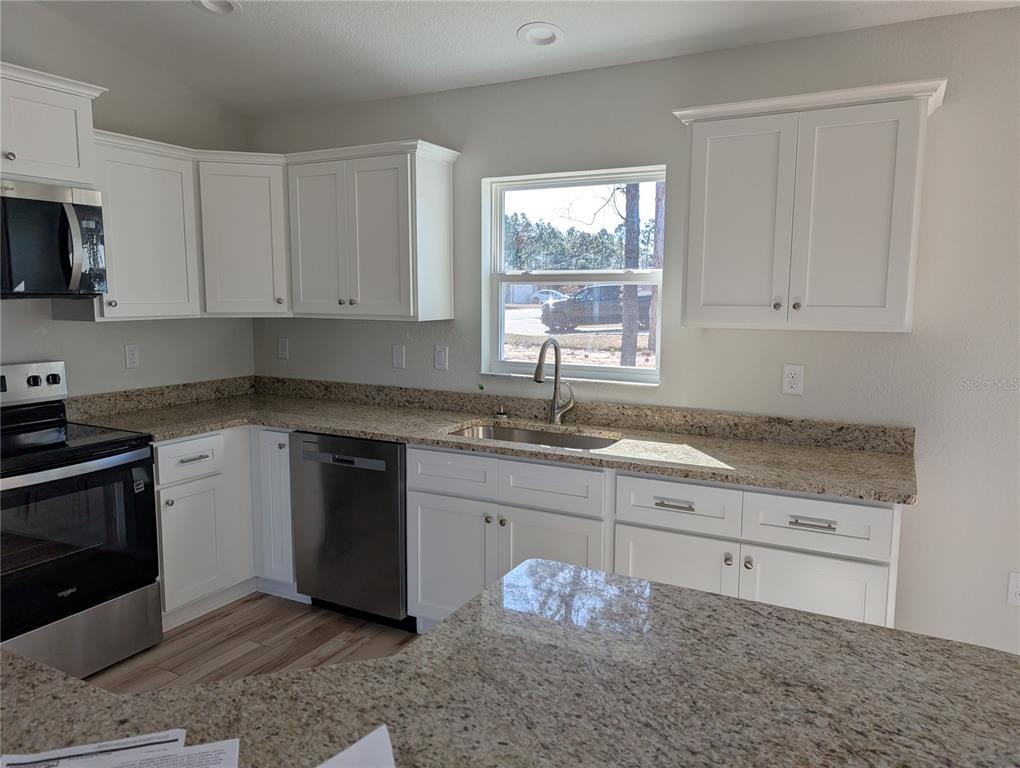 37 Fir Drive Trace Ocala, FL 34472 - Photo 11 of 31 a kitchen with granite countertop white cabinets and a sink