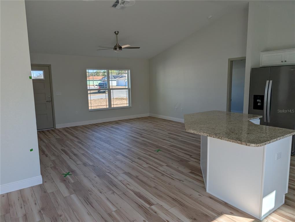 37 Fir Drive Trace Ocala, FL 34472 - Photo 14 of 31 an empty room with wooden floor and windows