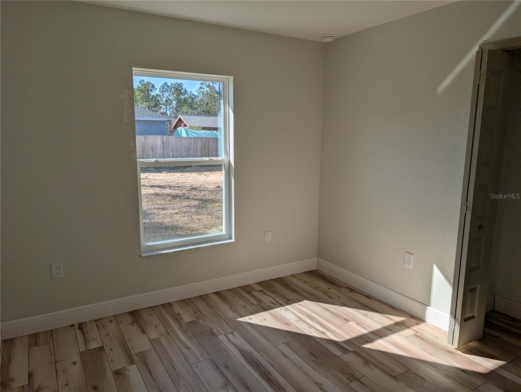37 Fir Drive Trace Ocala, FL 34472 - Photo 15 of 31 an empty room with wooden floor and windows