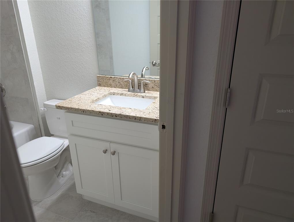 37 Fir Drive Trace Ocala, FL 34472 - Photo 18 of 31 a bathroom with a granite countertop sink toilet and mirror