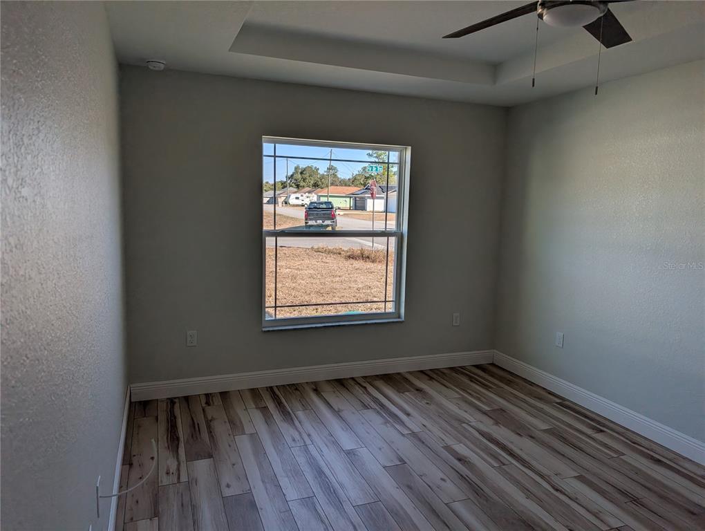 37 Fir Drive Trace Ocala, FL 34472 - Photo 21 of 31 a view of an empty room with wooden floor and a window
