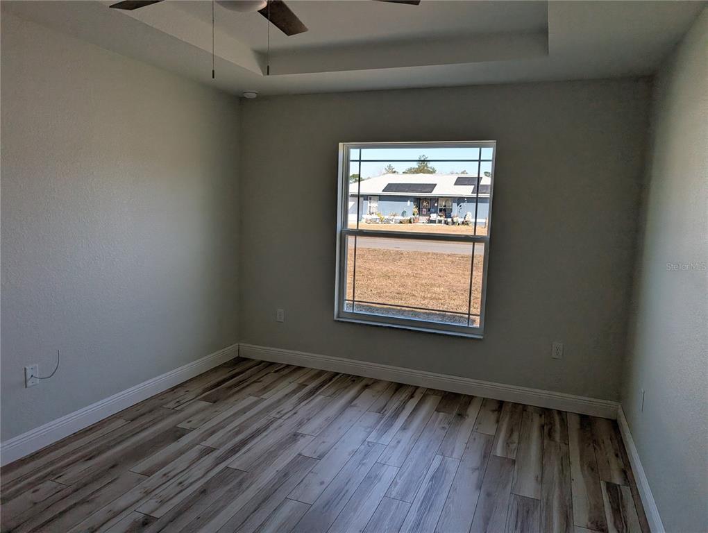 37 Fir Drive Trace Ocala, FL 34472 - Photo 22 of 31 a view of an empty room with wooden floor and a window