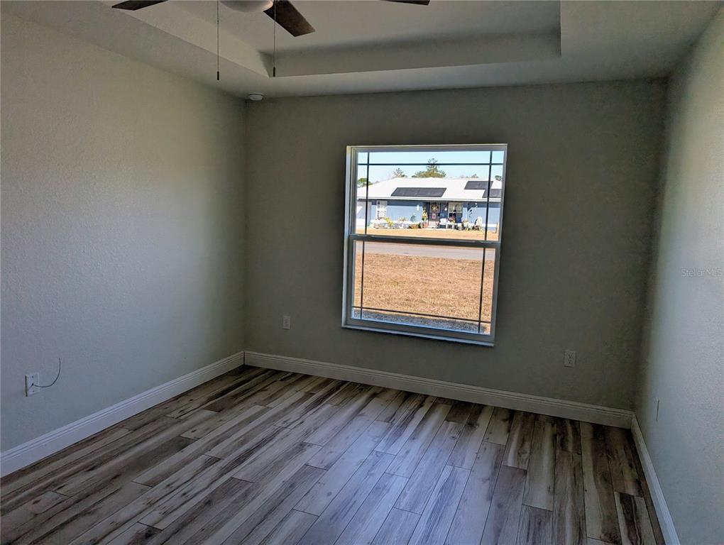 37 Fir Drive Trace Ocala, FL 34472 - Photo 23 of 31 a view of an empty room with wooden floor and a window