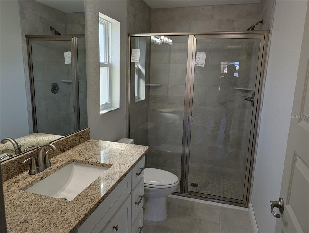 37 Fir Drive Trace Ocala, FL 34472 - Photo 25 of 31 a bathroom with a granite countertop sink toilet and shower