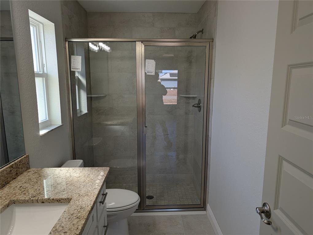 37 Fir Drive Trace Ocala, FL 34472 - Photo 26 of 31 a bathroom with a granite countertop sink toilet and shower