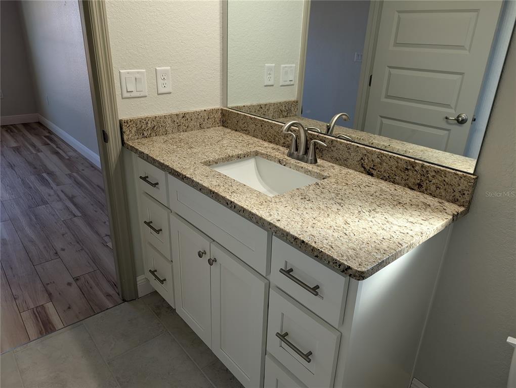 37 Fir Drive Trace Ocala, FL 34472 - Photo 27 of 31 a bathroom with a granite countertop sink and a mirror