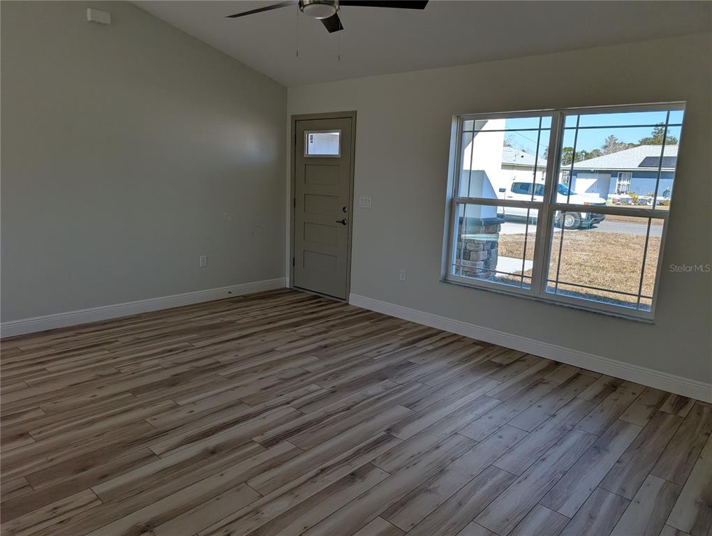37 Fir Drive Trace Ocala, FL 34472 - Photo 30 of 31 a view of an empty room with wooden floor and a window