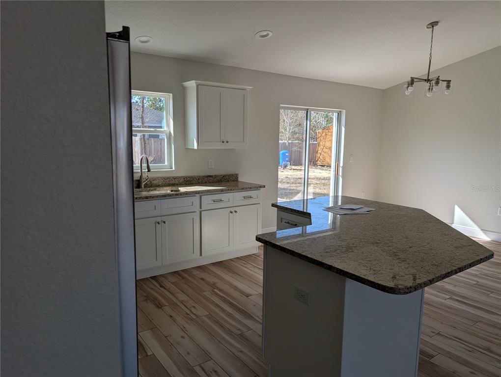 37 Fir Drive Trace Ocala, FL 34472 - Photo 31 of 31 a kitchen with kitchen island a sink stove and cabinets