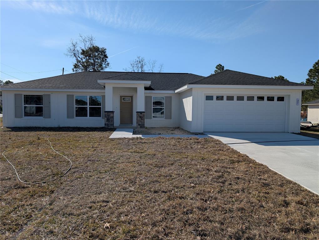 37 Fir Drive Trace Ocala, FL 34472 - Photo 6 of 31 a front view of a house with a yard