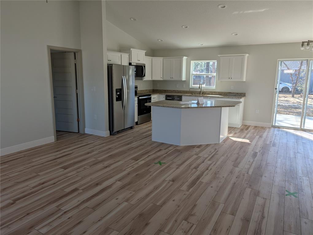 37 Fir Drive Trace Ocala, FL 34472 - Photo 7 of 31 a kitchen with wooden floors and refrigerator