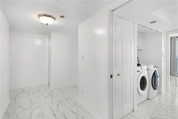 a view of a bathroom with washer and dryer