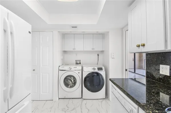 a utility room with sink dryer and washer