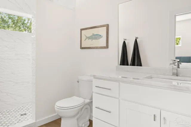 a bathroom with a toilet sink and vanity