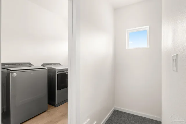 a view of storage and utility room with washer and dryer