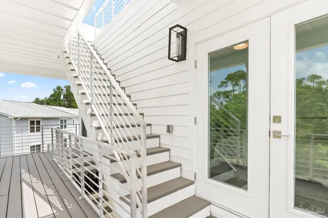 a view of entryway with wooden floor and stairs