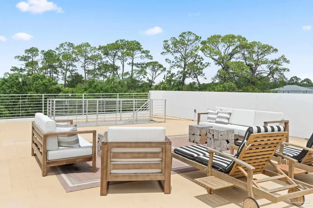 a view of a terrace with couches and wooden floor