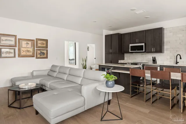 a living room with furniture and a wooden floor