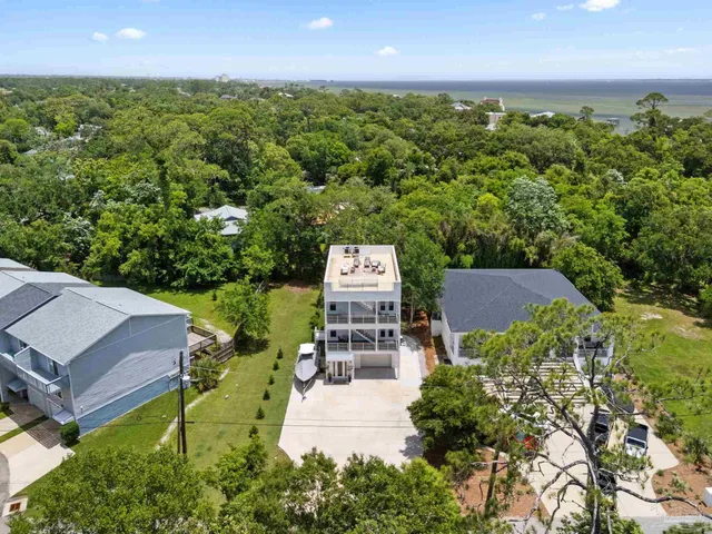 an aerial view of a house with garden space and street view