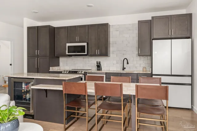 a kitchen with a stove top oven and sink
