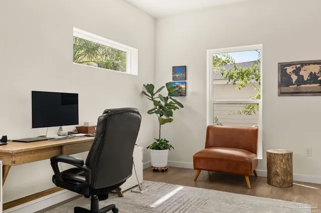 a view of a workspace with furniture and a potted plant