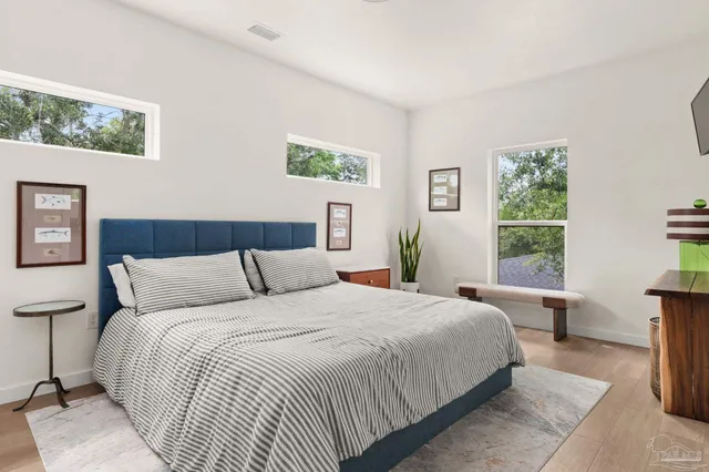 a bedroom with a large bed and a window