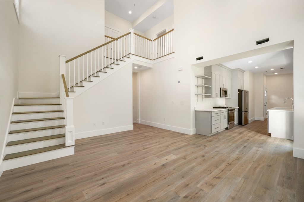 a view of a kitchen with wooden floor and a kitchen