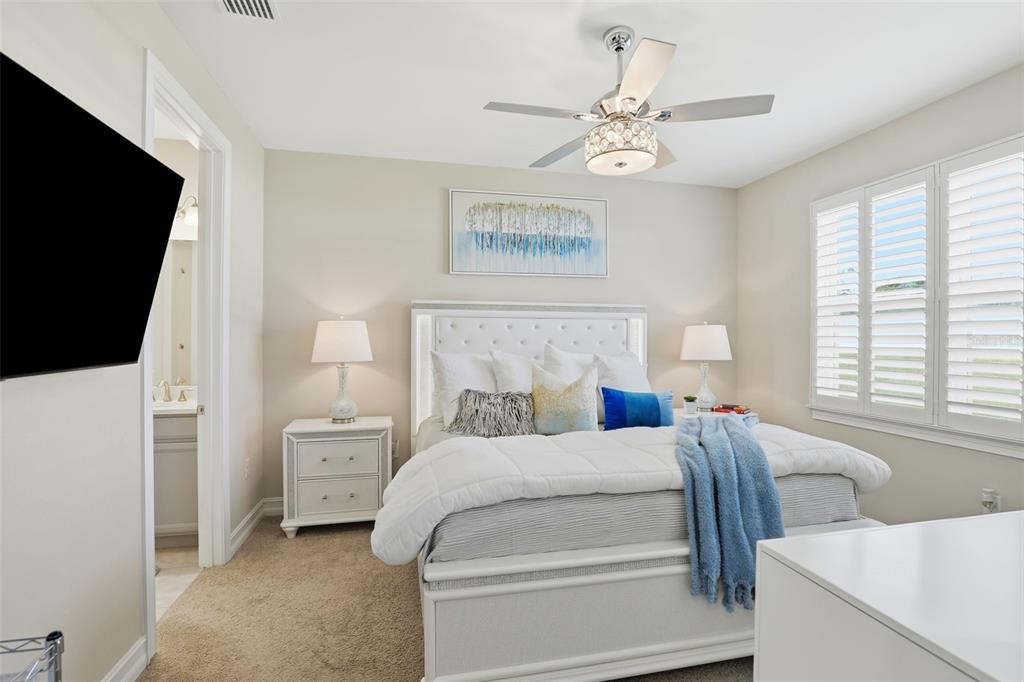 112 Ibiza Loop Venice, FL 34292 - Photo 15 of 35 a bedroom with a bed and a flat tv screen on dresser