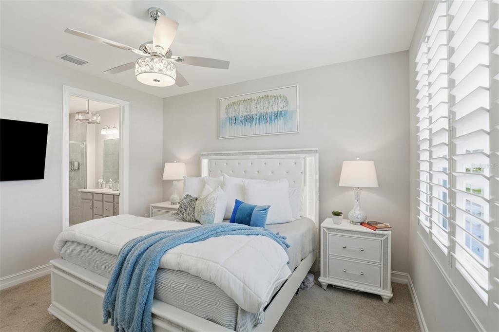 112 Ibiza Loop Venice, FL 34292 - Photo 16 of 35 a bedroom with a bed and a chandelier