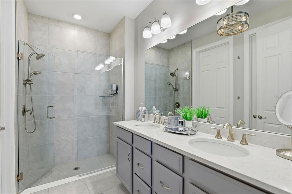 112 Ibiza Loop Venice, FL 34292 - Photo 18 of 35 a bathroom with a double vanity sink mirror and shower