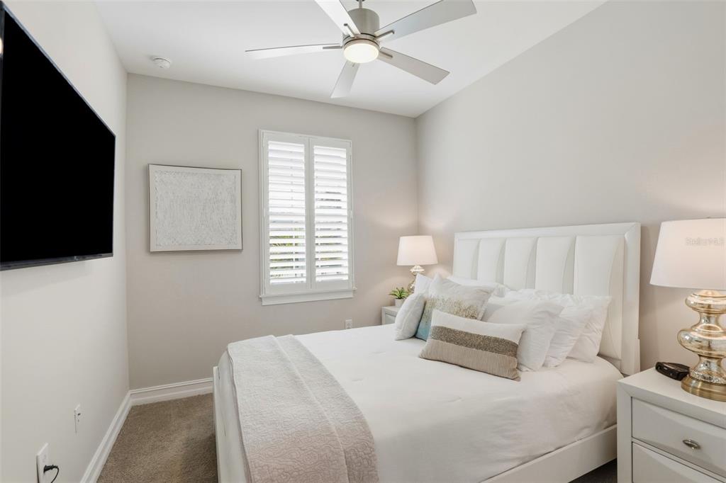 112 Ibiza Loop Venice, FL 34292 - Photo 20 of 35 a bedroom with a large bed and a flat tv screen on a dresser